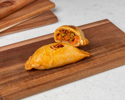 Classic Lamb Empanada filled with Aussie lamb mince, onions, tomato gravy, rosemary, baby carrots, and peas – golden pastry handmade by Cholito Empanadas in Sydney