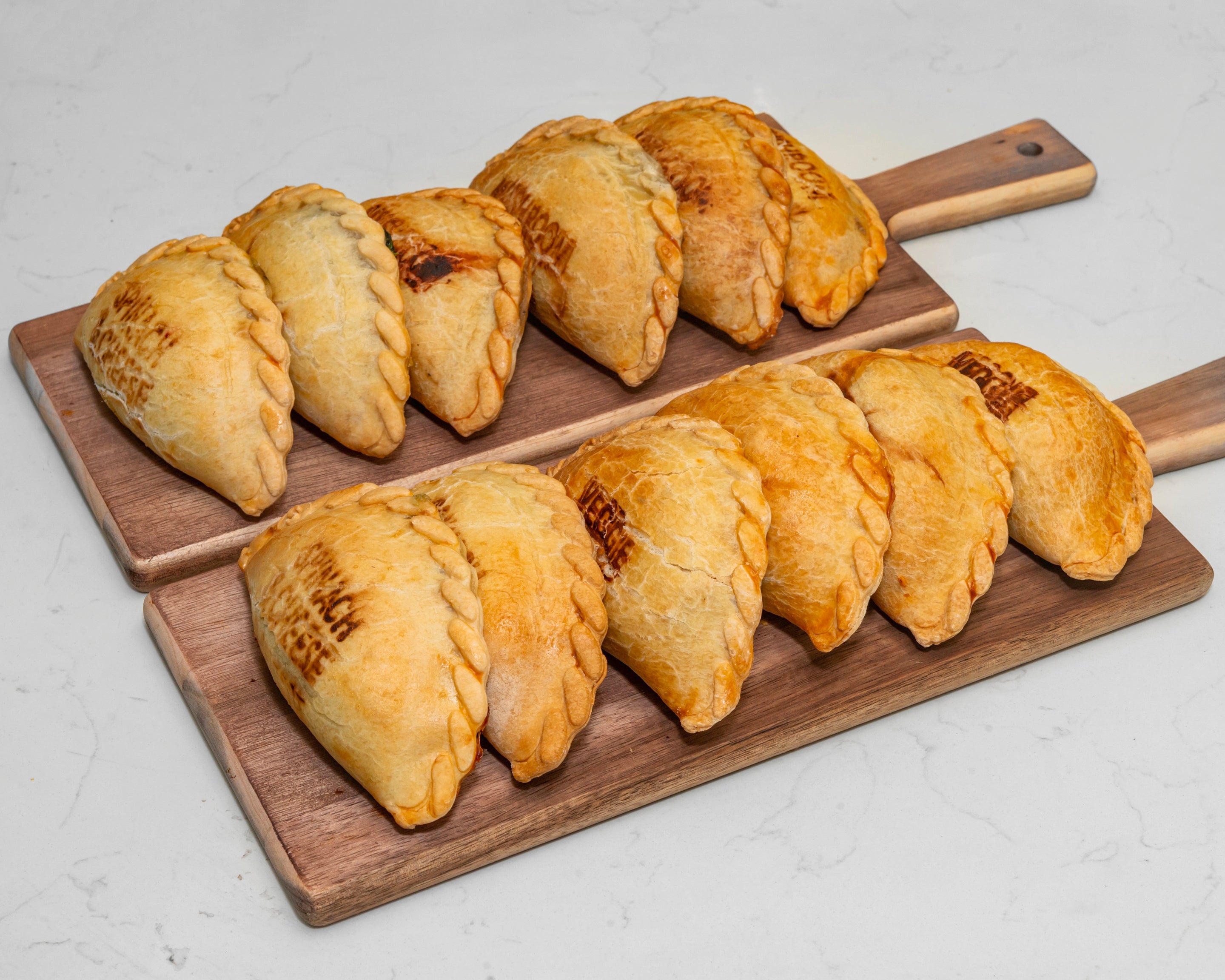 Veggie Lover Empanada Box with 12 golden empanadas filled with spinach & cheese, mushroom & leek, and seasonal vegetables – handmade vegetarian empanadas from Cholito in Sydney